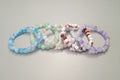 FIVE MULTI COLOR BEADED BRACLETS